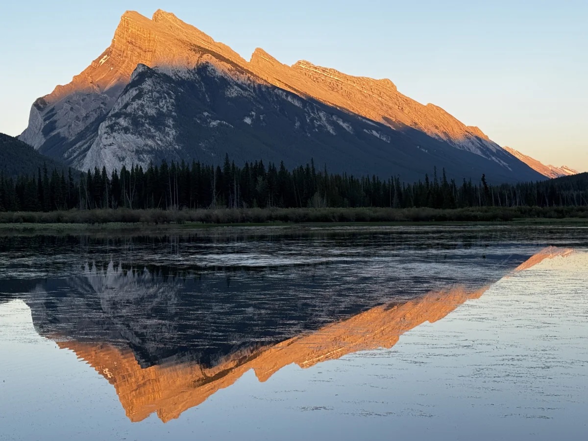Mount Rundle glowing in the day’s last light and reflected in Vermilion Lakes near Banff